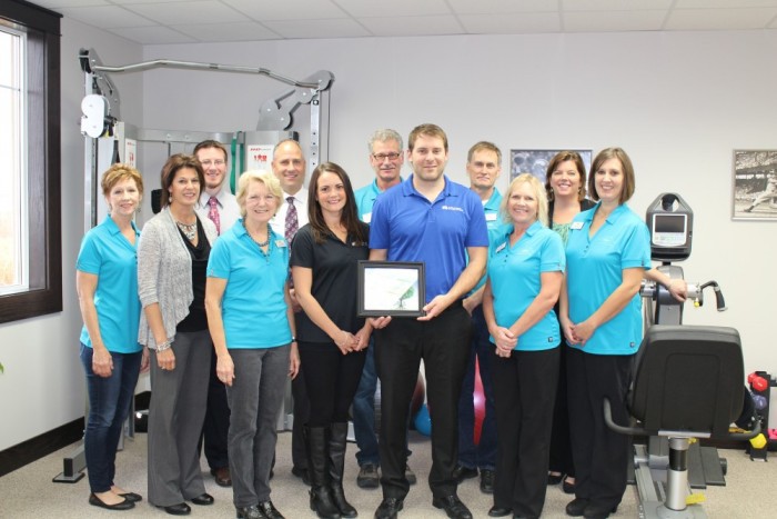 Members of Alexandria Chamber Membership team present Amos and Kendra Hartsell a 2015 Chamber Membership Plaque.